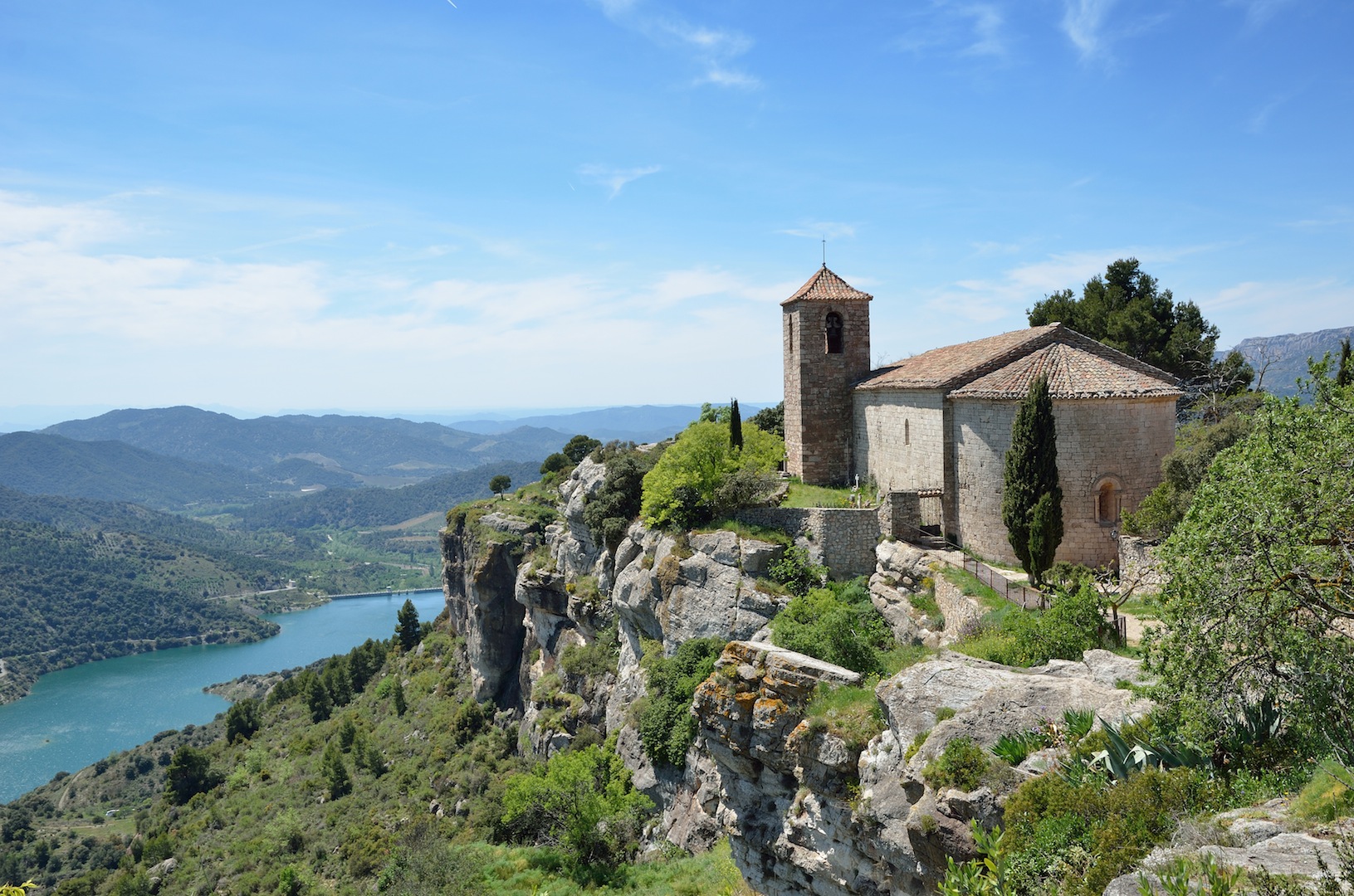 The antique church is extant in the old small village on the bluff cliff under the valley in the Prades Mountains.