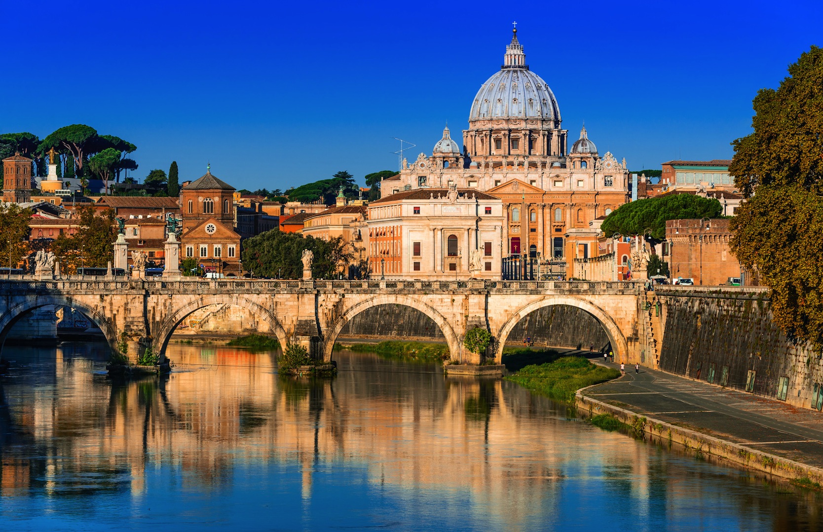 Rome, Italy. Vatican dome of San Pietro and Sant Angelo Bridge, over Tiber river.